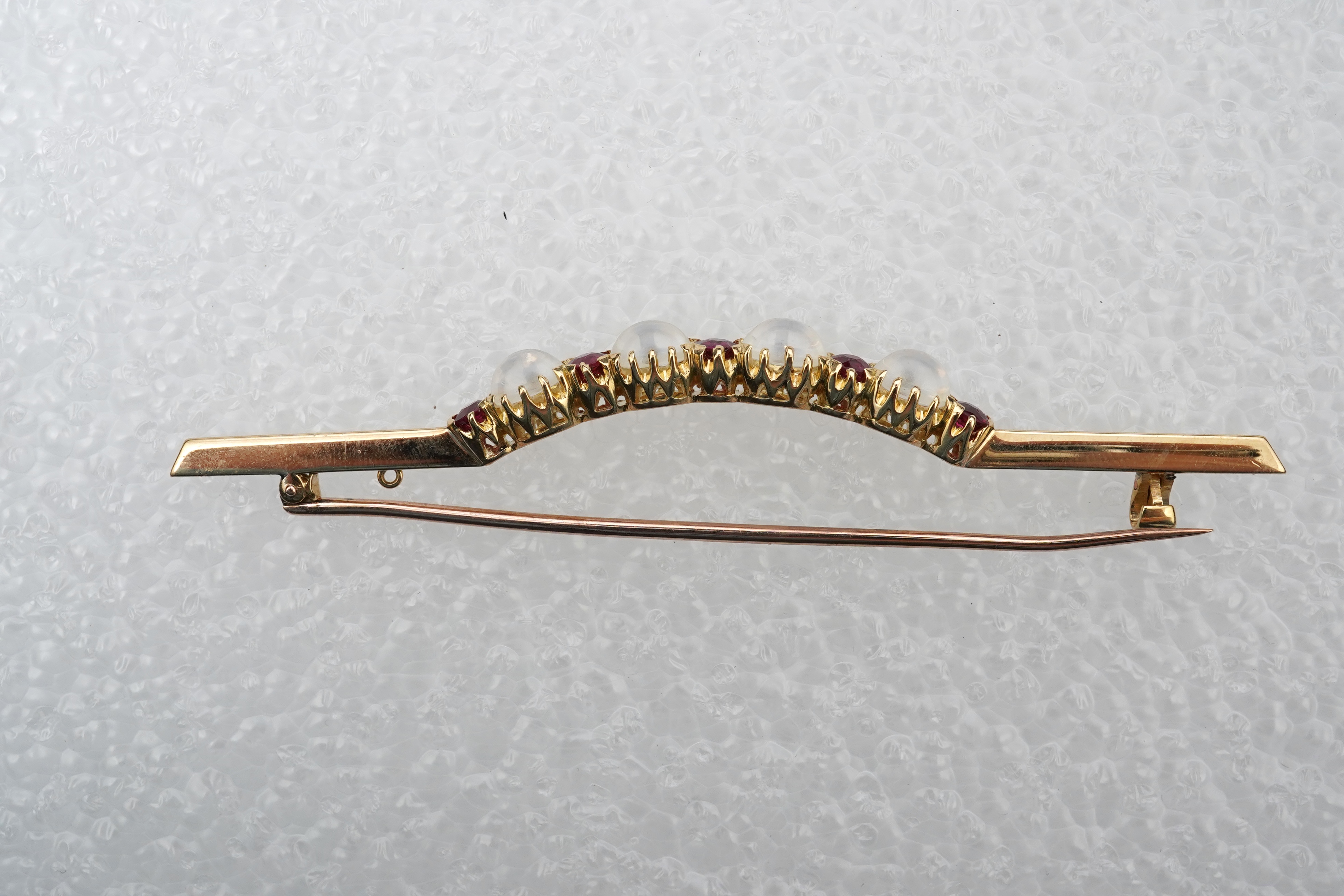 A moonstone and ruby brooch, circa 1900